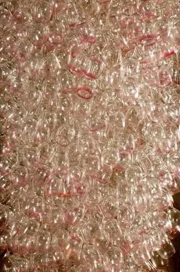 Here Come the Girls 2009
Manchester Art Gallery Atrium
1100 Wine Glasses
Lipstick
Commissioned by Manchester Art Gallery to celebrate the festive season and specifically to link to their exhibition Angels of Anarchy: Women Artists and Surrealism. The primary reference is to Meret Oppenheim's iconic fur teacup, saucer and spoon, Object. In a contemporary culture where women are just as likely to drink wine as tea the vessel still functions as a metaphor for the female body, but in the 21st century sexual politics have evolved.
Each glass is individually rimmed with lipstick using the artist's lips. Cosmetics, particularly lipstick, are often advertised as a way to enhance feminine power and choice, and one cosmetic company even used the slogan 'It's not makeup, it's ammunition'.
<em>"While thinking of 'strong women' femininity, power and Christmastime, I was reminded of the recent Boots TV commercials with crowds of women getting glammed up and marching out to celebrate to the Sugababes 'Here come the Girls'."</em> Susie MacMurray
The work offers a space for rumination on the evolution of feminism and perceptions of female power/empowerment in it's various guises – cultural/political/sexual. Also on the different ways women choose to exercise that empowerment (including binge drinking), the ambiguities it throws up, and psychological bargains we strike with ourselves.