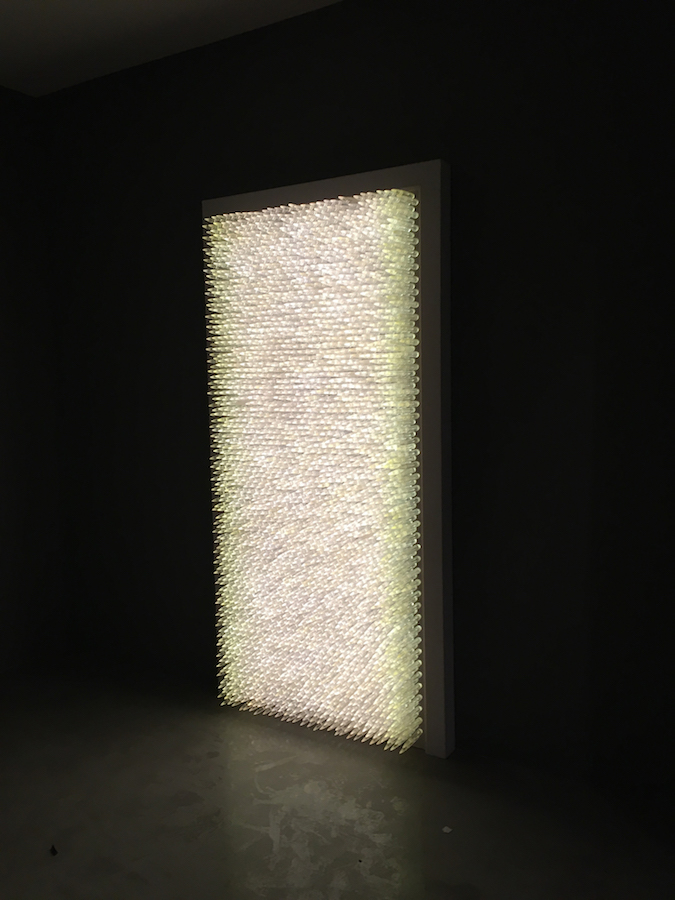 Pandora 2016; LED lightbox within doorframe; clear cast resin 50. cal Browning bullets; installation view, Akbank Sanat, Istanbul 2018 Pandora 2016; LED lightbox within doorframe; clear cast resin 50. cal Browning bullets; installation view, Akbank Sanat, Istanbul 2018
