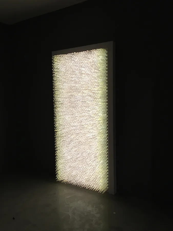 Pandora 2016; LED lightbox within doorframe; clear cast resin 50. cal Browning bullets; installation view, Akbank Sanat, Istanbul 2018 Pandora 2016; LED lightbox within doorframe; clear cast resin 50. cal Browning bullets; installation view, Akbank Sanat, Istanbul 2018