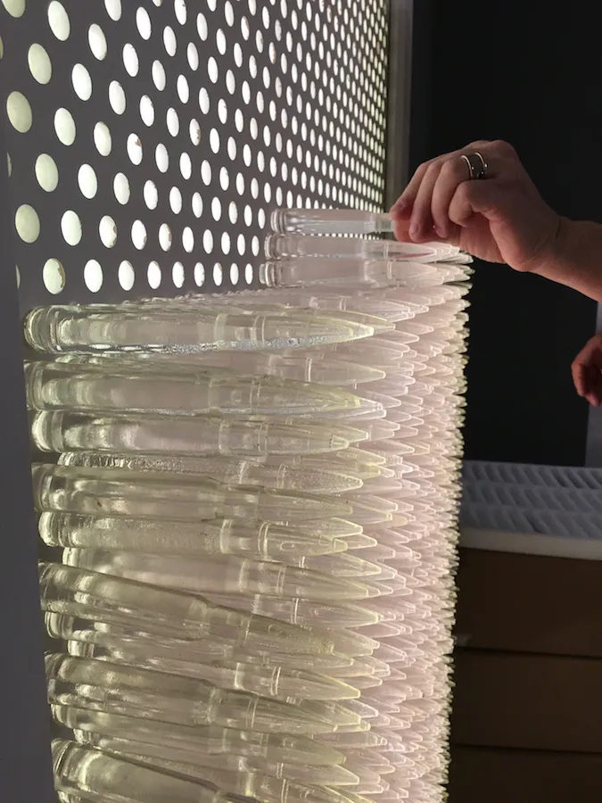 Pandora 2016; LED lightbox within doorframe; clear cast resin 50. cal Browning bullets; installation view, Akbank Sanat, Istanbul 2018 Pandora 2016; LED lightbox within doorframe; clear cast resin 50. cal Browning bullets; installation view, Akbank Sanat, Istanbul 2018